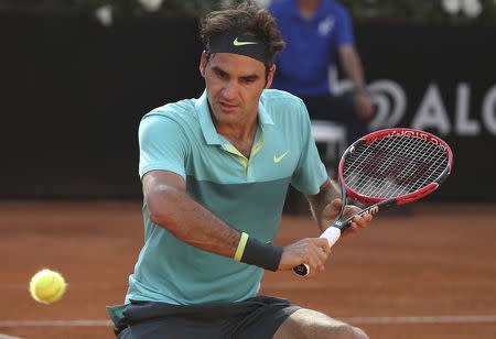 Roger Federer of Switzerland returns the ball to Novak Djokovic of Serbia during their final match at the Rome Open tennis tournament in Rome, Italy, May 17, 2015. REUTERS/Stefano Rellandini