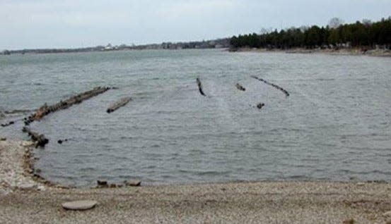 The remains of the Oak Leaf, at right, jut slightly of the the Sturgeon Bay channel at Bullhead Point, with the wreck of the Ida Loring also sticking up from the water at left Both ships along with the Empire State, all of which were used to haul stone, sank there in 1928.