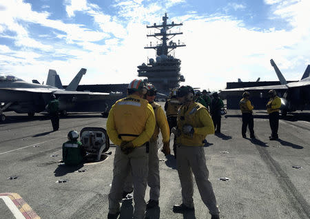 Crew members of the U.S. Navy aircraft carrier USS Ronald Reagan conduct military drills during Keen Sword, a joint field-training exercise involving U.S. military, Japan Maritime Self-Defense Force personnel and Royal Canadian Navy, at sea November 3, 2018. REUTERS/Tim Kelly