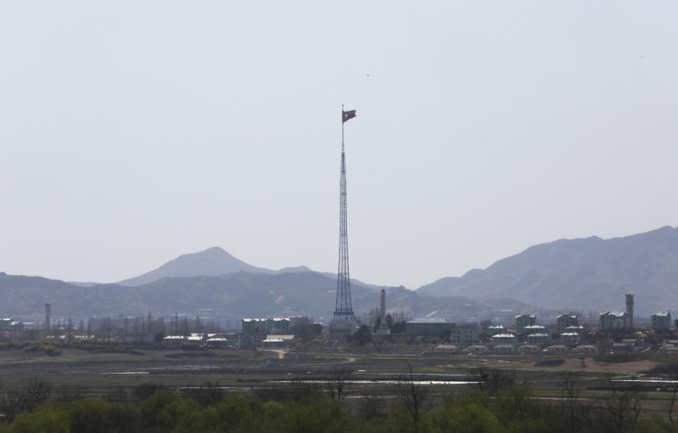 FILE - In this April 11, 2018 file photo, a North Korean flag flutters in the wind near the border villages of Panmunjom in Paju, South Korea. North and South Korea began removing mines at two sites inside their heavily fortified border Monday, Oct. 1 as part of their recent deals to ease decades-long military tensions. They will likely end up pulling out a very small portion of an estimated 2 million mines littered inside and near the 248-kilometer (155-mile) -long, 4-kilometer (2.5-mile) -wide Demilitarized Zone. But it would be the rivals’ first joint demining work in more than a decade and comes amid international diplomacy aimed at ridding North Korea of its nuclear weapons.(AP Photo/Ahn Young-joon, File)