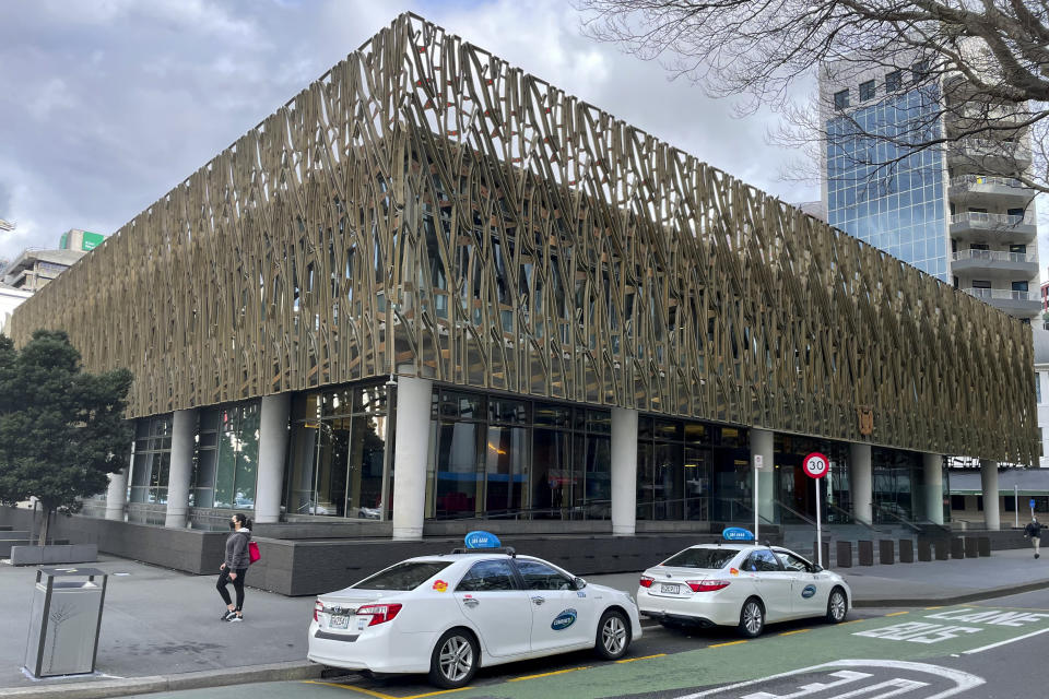 Taxis wait outside the Supreme Court in Wellington, New Zealand, Thursday, Aug. 25, 2022. Exclusive documents obtained by The Associated Press show that New Zealand tax payers could bear the cost of millions of dollars to monitor the treatment of a soon to be extradited murder suspect to Shanghai. (AP Photo/Nick Perry)