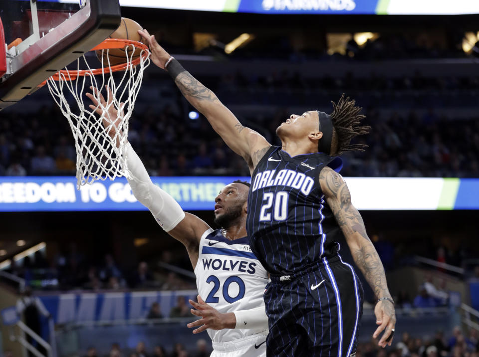 Orlando Magic guard Markelle Fultz, right, blocks a shot by Minnesota Timberwolves guard Josh Okogie, but was then called for goaltending during the first half of an NBA basketball game Friday, Feb. 28, 2020, in Orlando, Fla. (AP Photo/John Raoux)