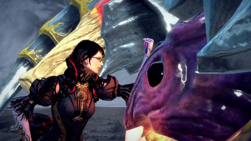 Bayonetta bonks the head of a giant spider demon. 