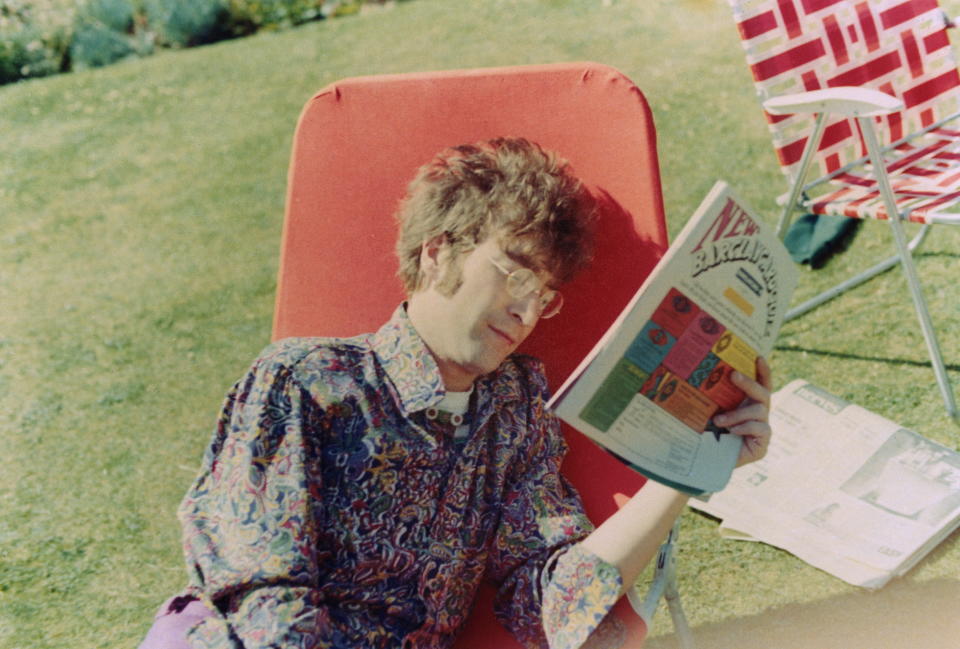 LONDON - 1st JANUARY: John Lennon (1940-1980) from the Beatles reads a magazine on a garden lounger in London, summer 1967. (Photo by Mark and Colleen Hayward/Redferns)