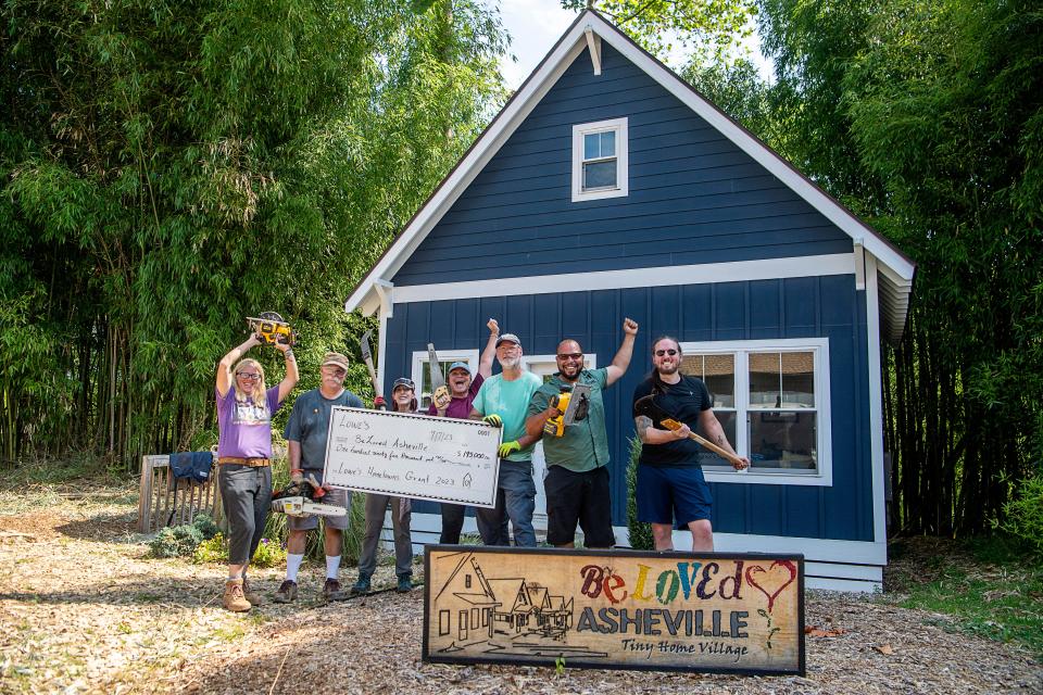 Volunteers pose with a $195,000 check from the Lowe’s Hometowns grant program July 13, 2023.