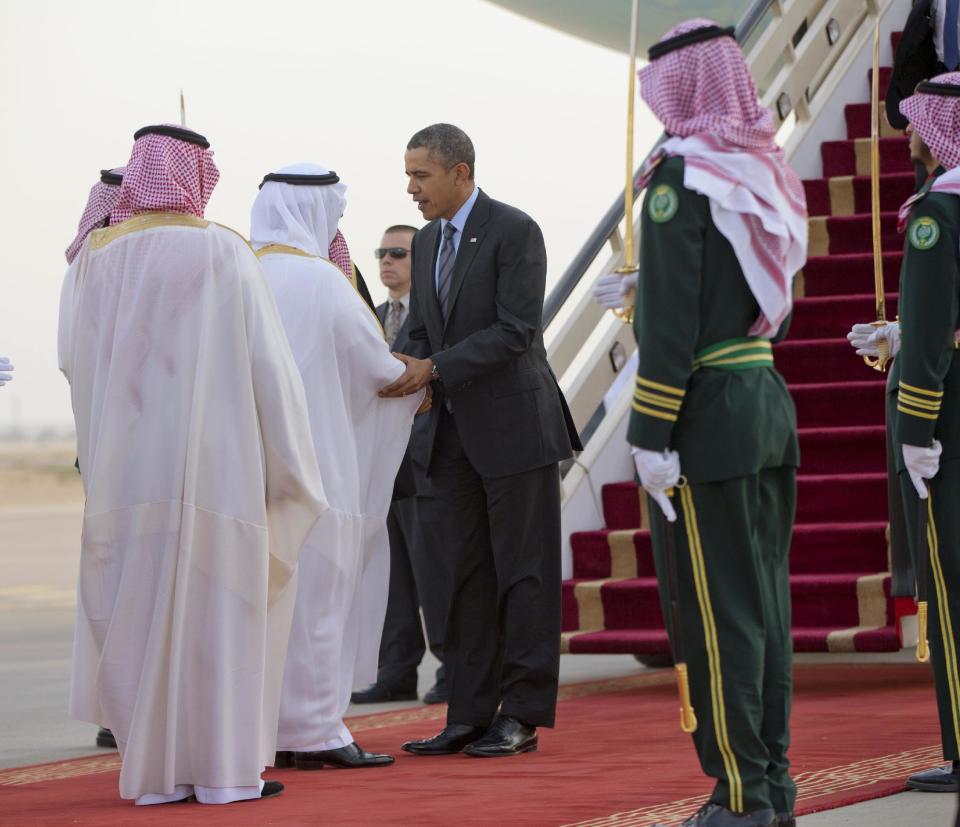 President Barack Obama is greeted by members of the Saudi delegation upon his arrival on Air Force One at King Khalid International airport in Riyadh, Saudi Arabia, Friday, March 28, 2014. President Barack Obama is in Saudi Arabia to reassure the key Gulf ally that his commitment to the Arab world isn't wavering. (AP Photo/Pablo Martinez Monsivais)