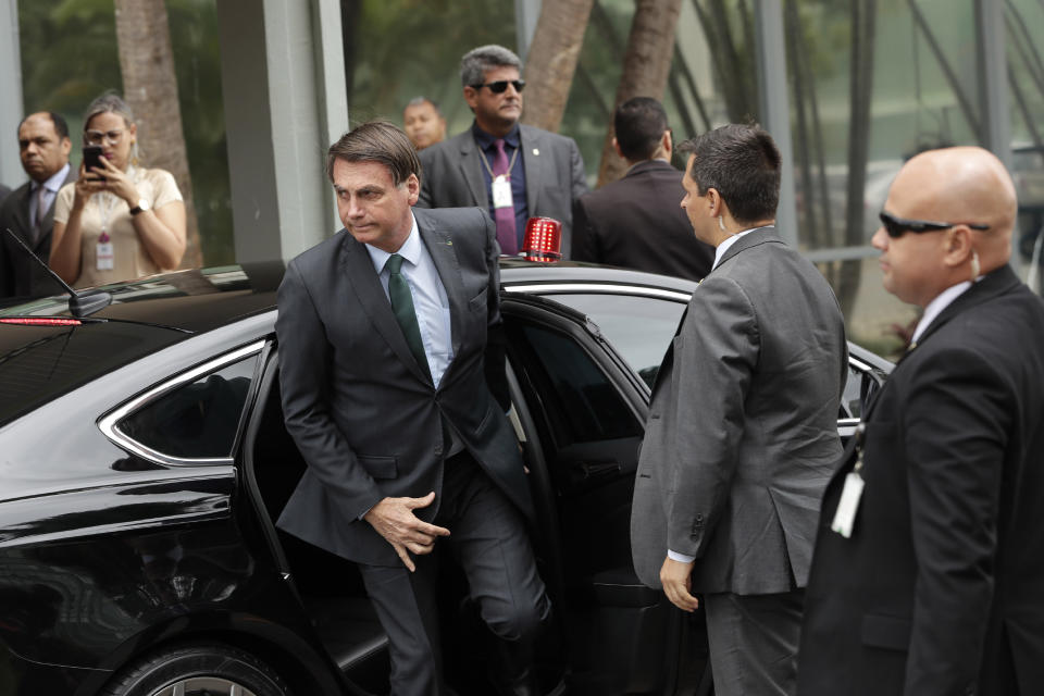 Brazil's President Jair Bolsonaro exits his car for a meeting with military commanders at the Defense Ministry in Brasilia, Brazil, Tuesday, Jan. 7, 2020. Bolsonaro spoke about maintaining commercial ties with Iran this morning, saying he would speak to his foreign minister about talks with Iran and reiterated that Brazil opposes terrorism. (AP Photo/Eraldo Peres)