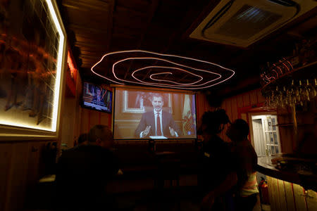 Patrons in a restaurant watch as Spanish King Felipe makes a televised address to the nation in Madrid, Spain, October 3, 2017. REUTERS/Rafael Marchante