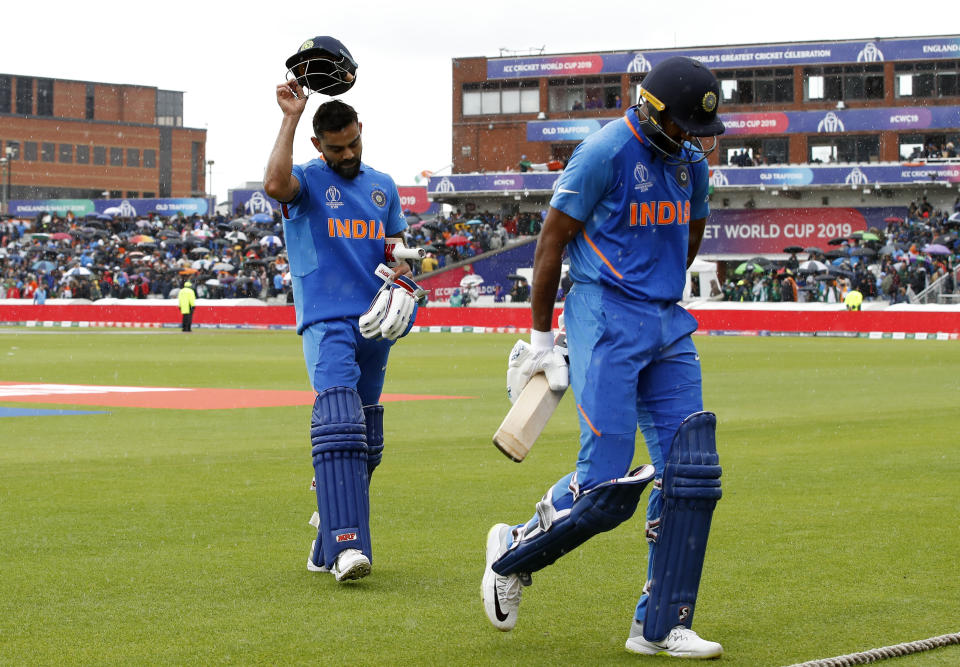 A frustrated Kohli and Shankar walk off as rain stops play (Photo by Martin Rickett/PA Images via Getty Images)