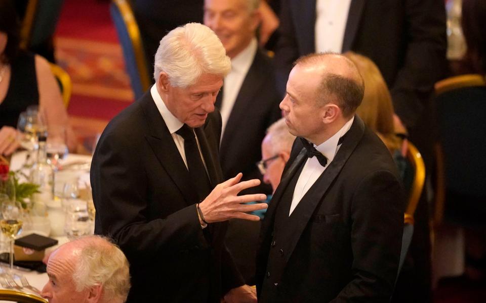 Former US President Bill Clinton (left) meets with Secretary of State for Northern Ireland Chris Heaton-Harris at a banquet at Belfast City Hall - Niall Carson