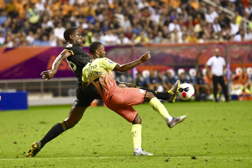 Willy Boly of the Wolverhampton Wanderers, left, vies against Raheem Sterling of Manchester City in the final of the Premier League Asia Trophy in Shanghai, China Saturday, July 20, 2019. Wolverhampton Wanderers beat the Manchester City in the final by 3-2 in the penalty shoot-out. (Chinatopix Via AP) CHINA OUT