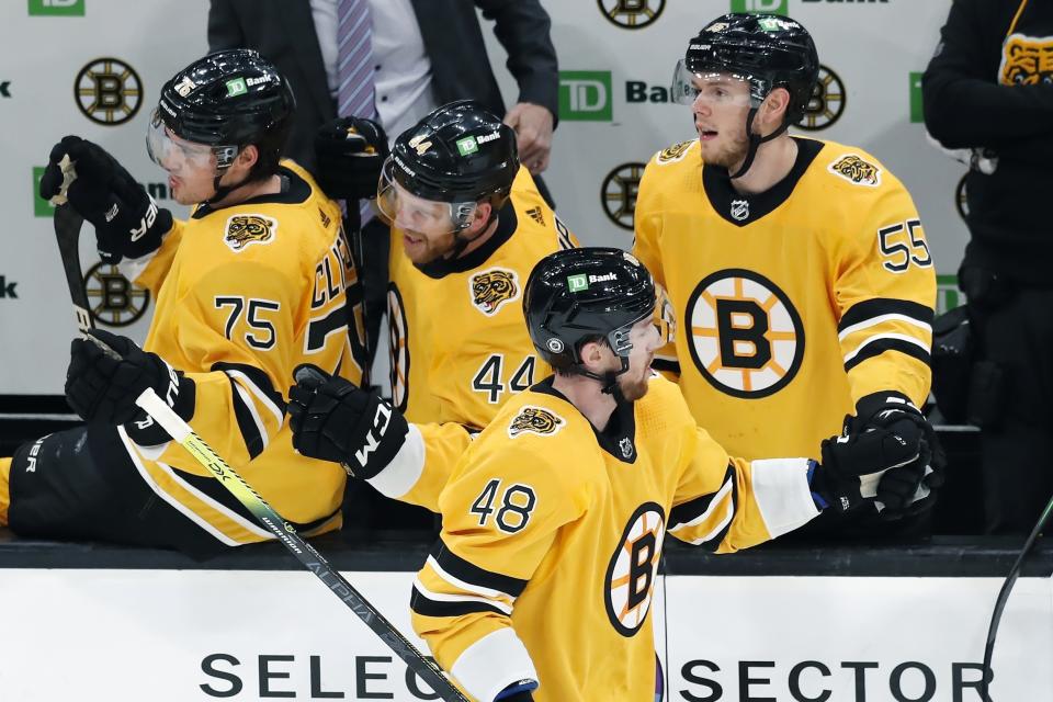 Boston Bruins' Matt Grzelcyk (48) celebrates his gaol during the second period of an NHL hockey game against the Buffalo Sabres, Saturday, March 27, 2021, in Boston. (AP Photo/Michael Dwyer)