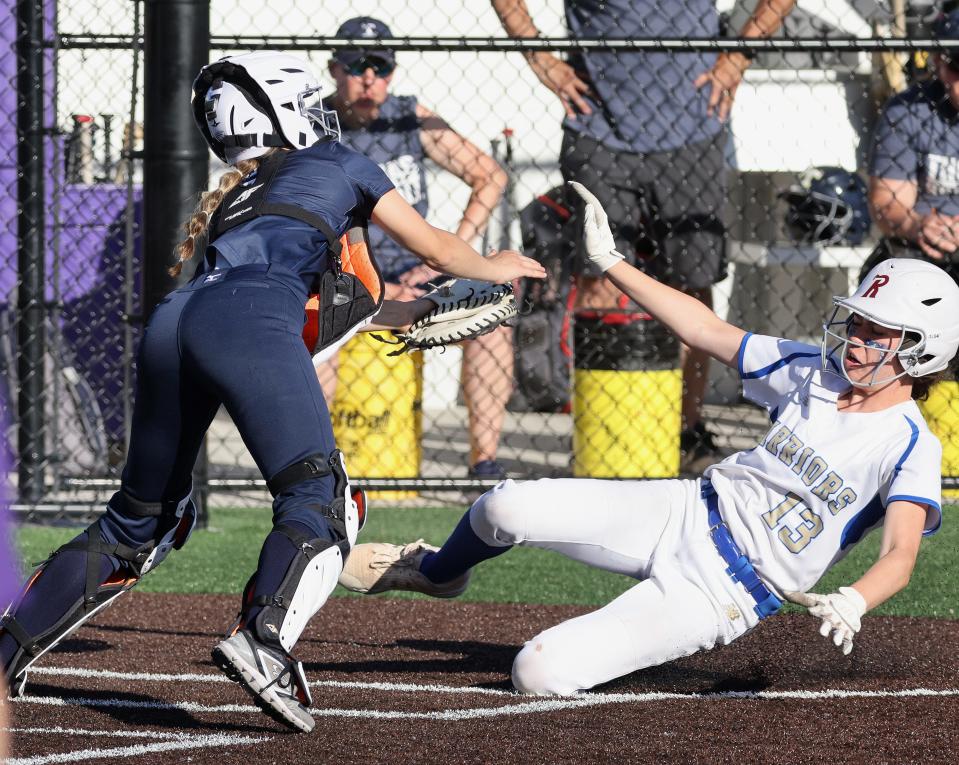 Schroeder's Sarah Ferruzza is tagged out by Thomas catcher Anna Bello in 2022.