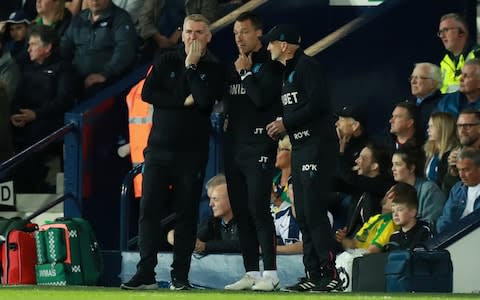 Dean Smith, Manager of Aston Villa in discussion with coaches John Terry and Richard O'Kelly during the Sky Bet Championship Play-off semi final second leg match between West Bromwich Albion and Aston Villa - Credit: Getty images