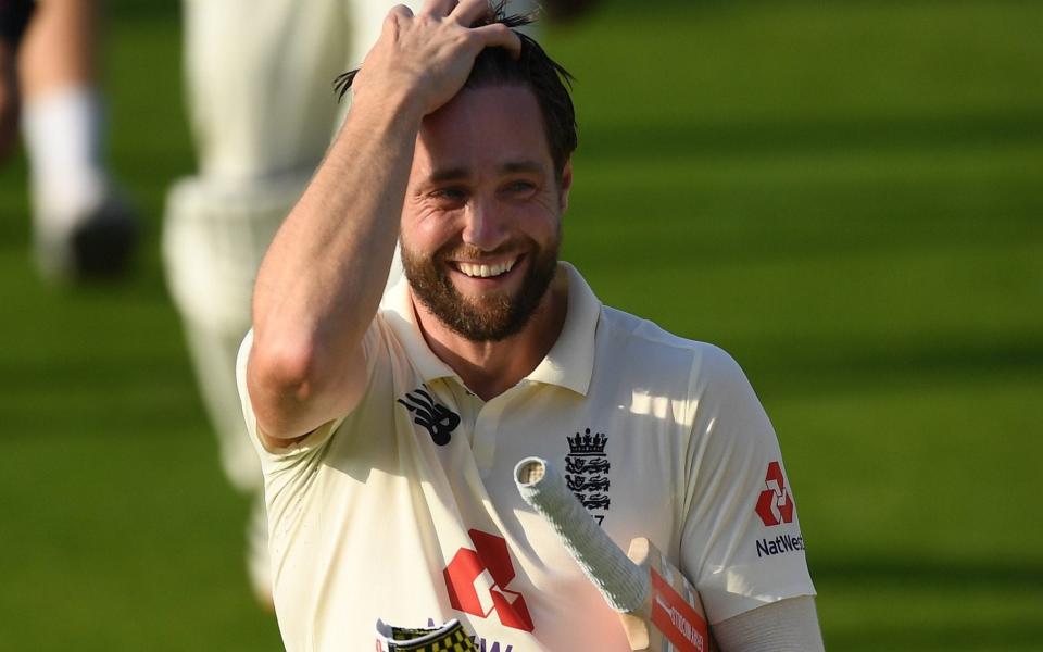 A smiling Chris Woakes walks off the pitch after winning the first Test for England - GETTY IMAGES