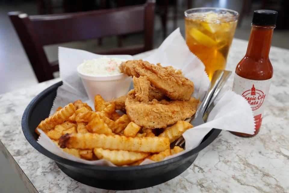 Fresh made fried chicken fingers with coleslaw and fries at Classic City Eats in Watkinsville, Ga.