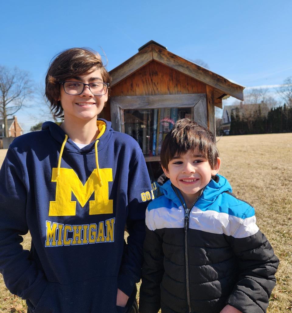 Alex and Wesley Murphy visit one of the Little Free Libraries located in Monroe County where books are free to take and read.