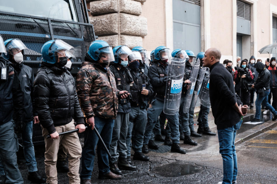 A protester in Rome harangues a line of anti-riot Italian police officers during a demonstration of small business owners protesting against the Mario Draghi government's lockdown rules. (Photo by Sirio Tessitore/NurPhoto via Getty Images)