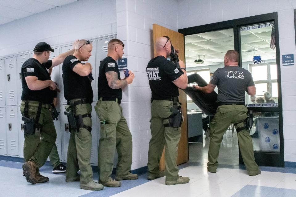 SWAT team members show students at the Cambridge Police Youth Citizens Academy how they would respond if there was ever an incident at the school.