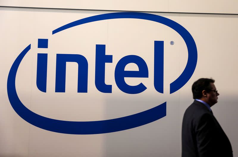FILE PHOTO: A visitor passes an Intel logo at the Mobile World Congress in Barcelona