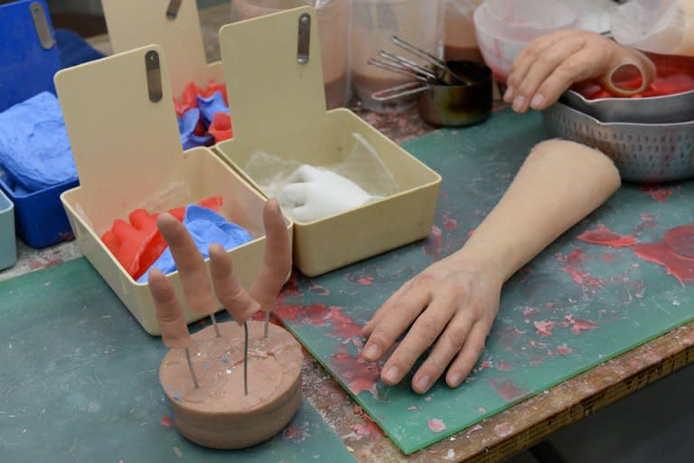 Silicone-made fingers and limbs are seen on a work bench at prosthetics specialist Shintaro Hayashi's office in Tokyo, on May 27, 2013. Going straight after a lifetime spent as a member of Japan's feared yakuza organised crime mobs poses a number of challenges. Chief among them is what to do about the fingers you chopped off