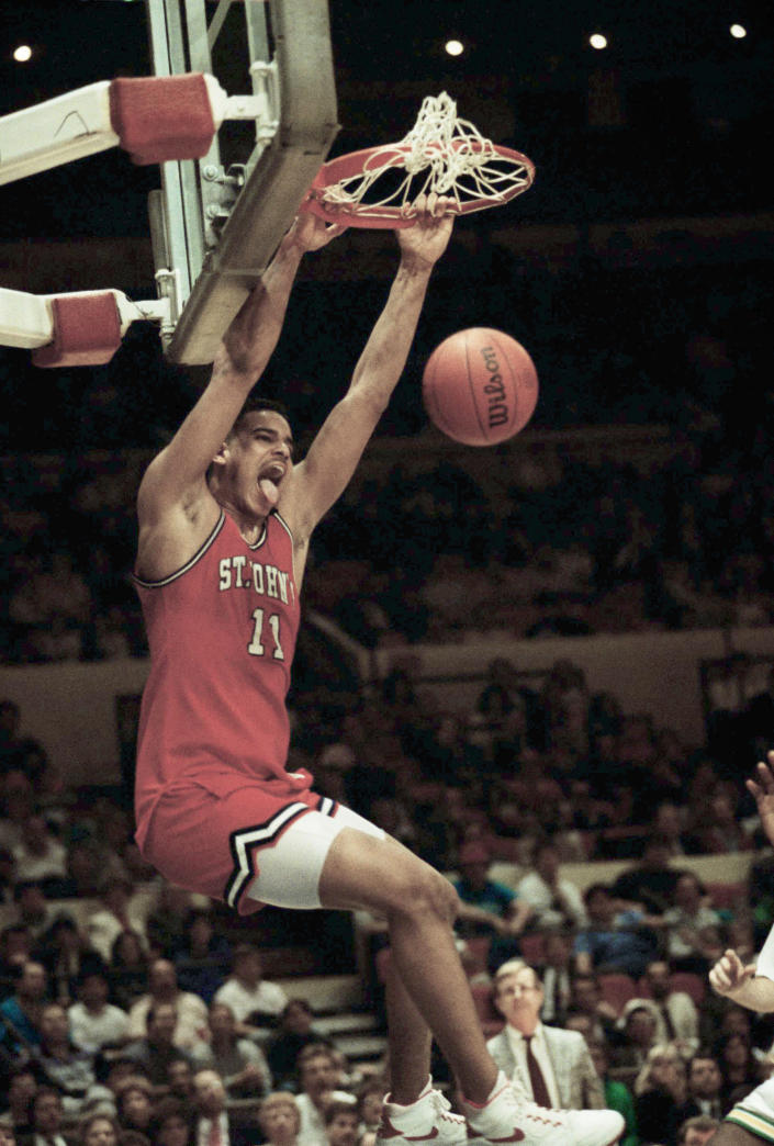 FILE - St. John's University's Jayson Williams exults after he scored two of his 17 points against the University of Alabama-Birmingham at New York's Madison Square Garden on Monday, March 28, 1989. The teenage daughters of former NBA All-Star Jayson Williams have denounced St. John’s University for its decision to induct their father into the school’s Athletics Hall of Fame. Tryumph and Whizdom Williams both wrote open letters they sent Friday, Oct. 21, 2022, to The Associated Press, and also planned to send to St. John’s, that said the school should be ashamed for his induction into the class during Saturday’s homecoming weekend. (AP Photo/Ron Frehm, File)