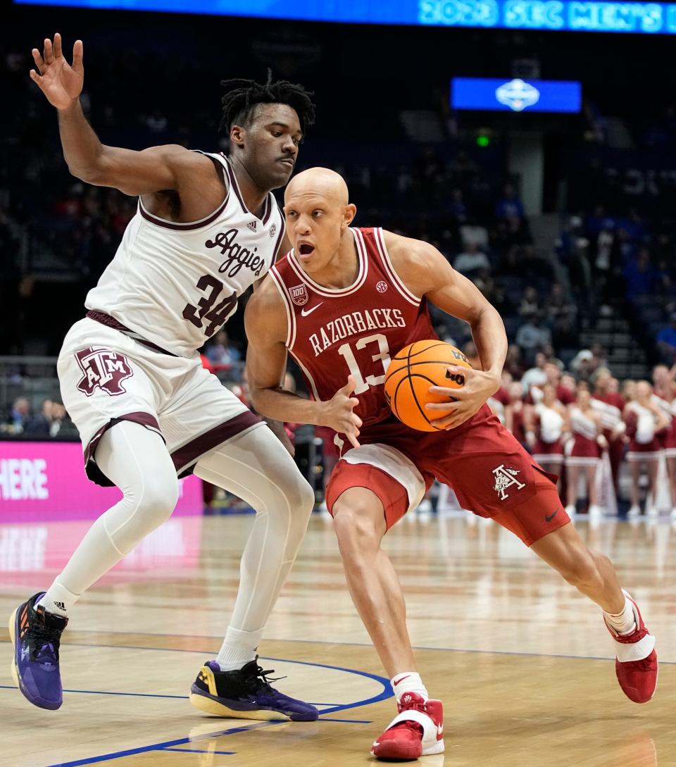 Arkansas guard Jordan Walsh (13) drives past Texas A&M forward Julius Marble (34) during the first half of a quarterfinal SEC Men’s Basketball Tournament game at Bridgestone Arena Friday, March 10, 2023, in Nashville, Tenn. 