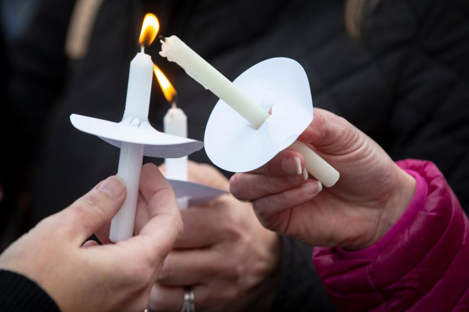 Mourners light candles as they line up along Bardstown Road to pay their respects to Lesley Prather and her daughter, Rhyan, along with Carrie McCaw and her daughter, Kacey. All four were killed in a car crash in Missouri.Feb. 17, 2020