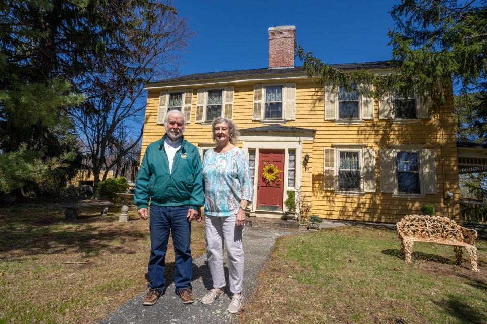 John and Barbara Cullen stand in front of the Whipple-Cullen Farmstead in Lincoln. Built in 1713, it is listed on the National Register of Historic Places.