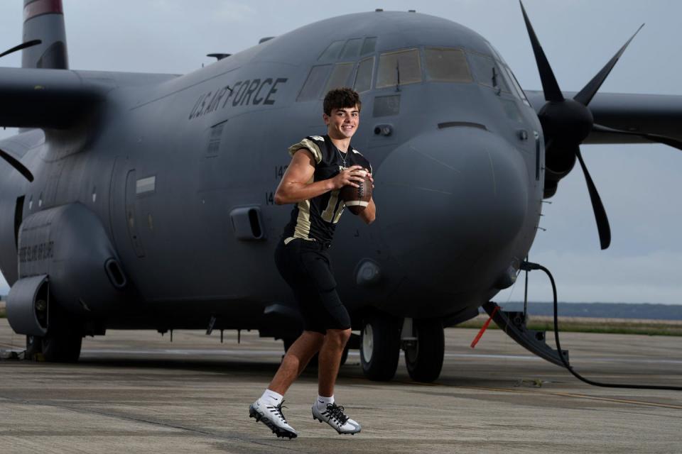 North Kingstown HS Skipper QB Eddie Buehler in front of a Lockheed Martin C-130J Super Hercules with the 143rd Airlift Wing, a unit of the RI Air National Guard, stationed at Quonset Point Air National Guard Station in North Kingstown, RI.  Photographed Sept 13, 2022.