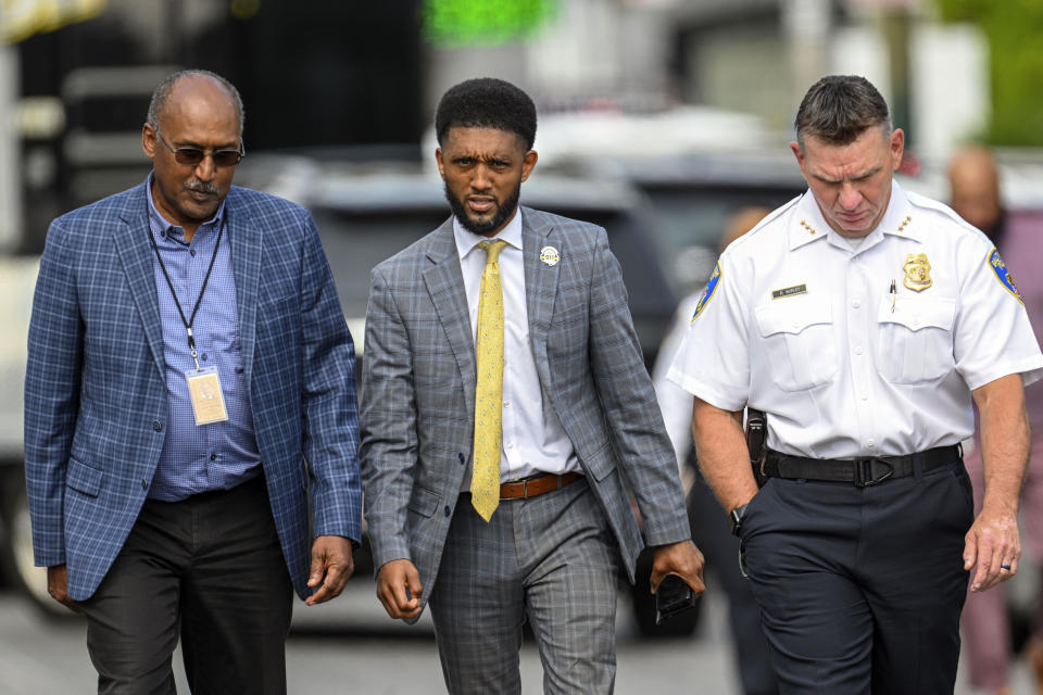 Baltimore Mayor Brandon Scott, center is flanked by consent decree monitor Ken Thompson, left, and Baltimore Deputy Police Commissioner Richard Worley as they walk to a press conference following an officer involved shooting in the Shipley Hill neighborhood of Baltimore, Thursday afternoon, May 11, 2023. (Jerry Jackson/The Baltimore Sun via AP)