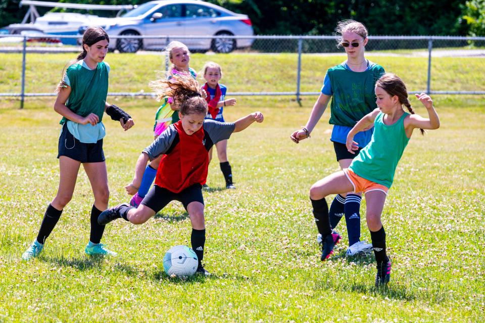 Izzy McKeon fakes a shot  at the MATTREC Girls Soccer Clinic hosted by Meg Hughes at Old Rochester.