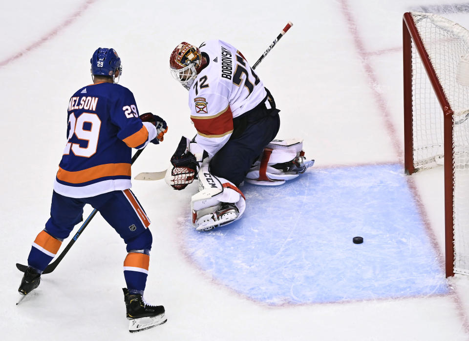 New York Islanders centre Brock Nelson (29) watches the puck go past Florida Panthers goaltender Sergei Bobrovsky (72) during the second period of an NHL Stanley Cup playoff hockey game in Toronto, Tuesday, Aug. 4, 2020. (Nathan Denette/The Canadian Press via AP)