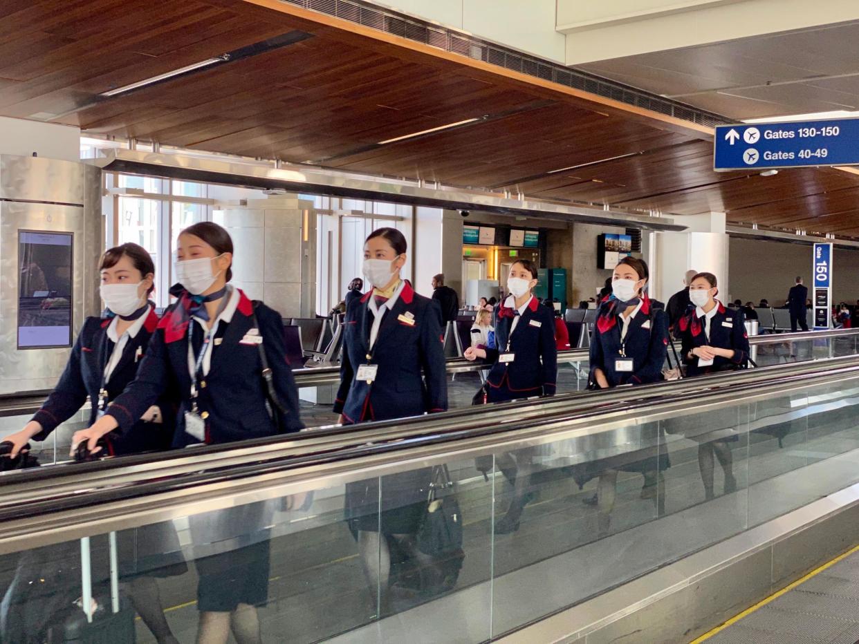 Japan Airline crew are seen at Los Angeles International Airport wearing masks to prevent coronavirus infection: Getty