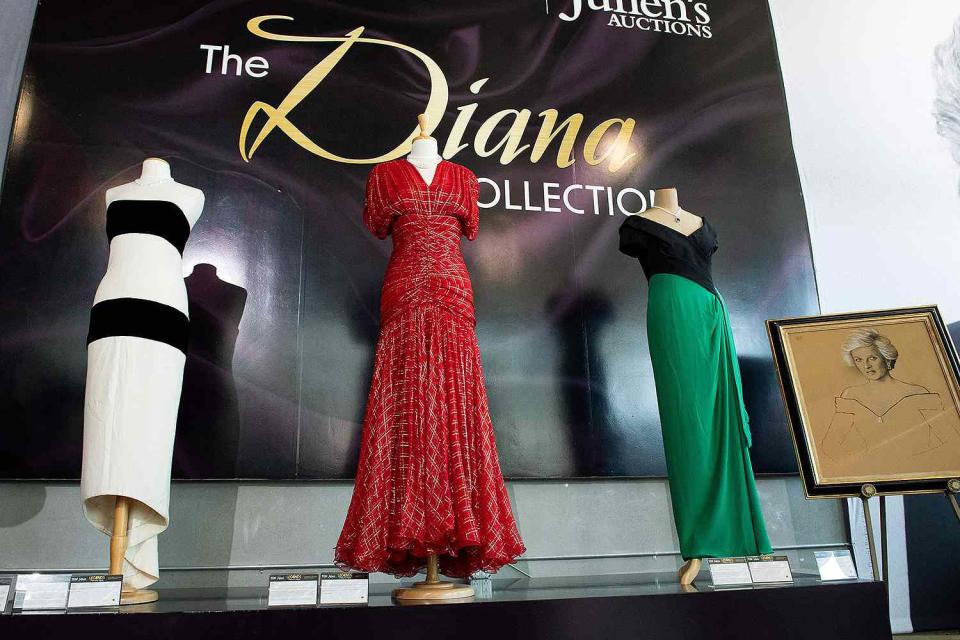 <p>VALERIE MACON/AFP via Getty </p> Dresses belonging to Princess Diana are displayed during the media preview for Julien