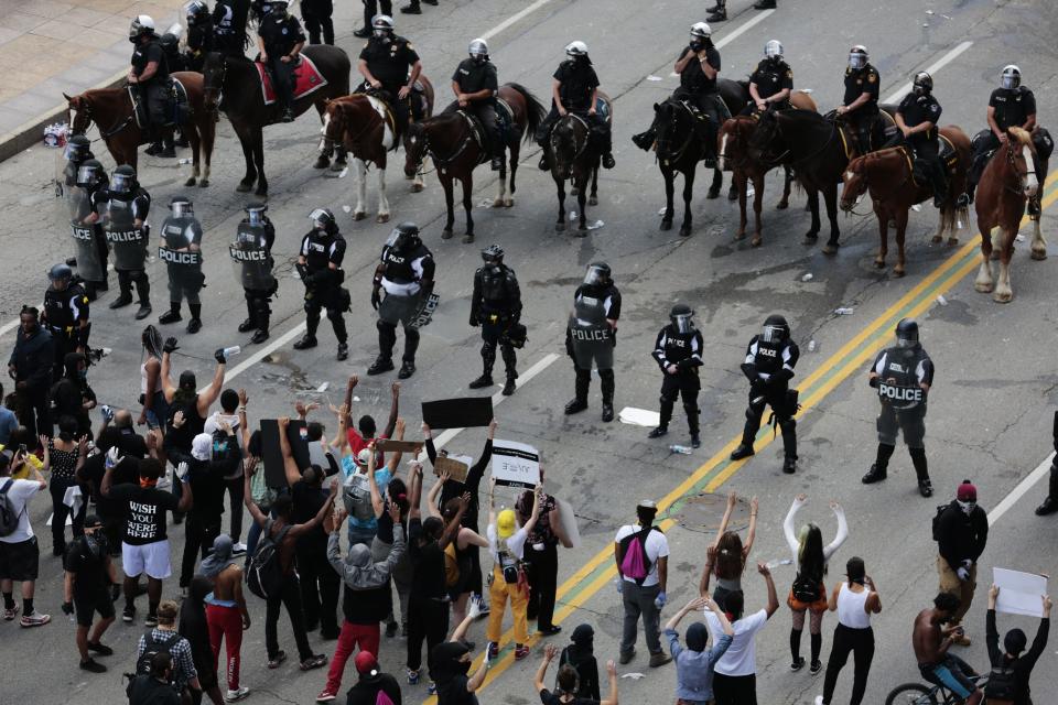 Peaceful demonstrators stand in the middle of Broad Street as Columbus Division of Police officers attempt to move them from the area during protests following the death of Minneapolis man George Floyd on Saturday, May 30, 2020 in Columbus, Ohio.