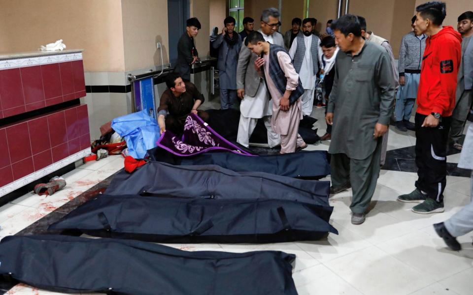 Afghan men look for their relatives at a hospital after the bombing - REUTERS