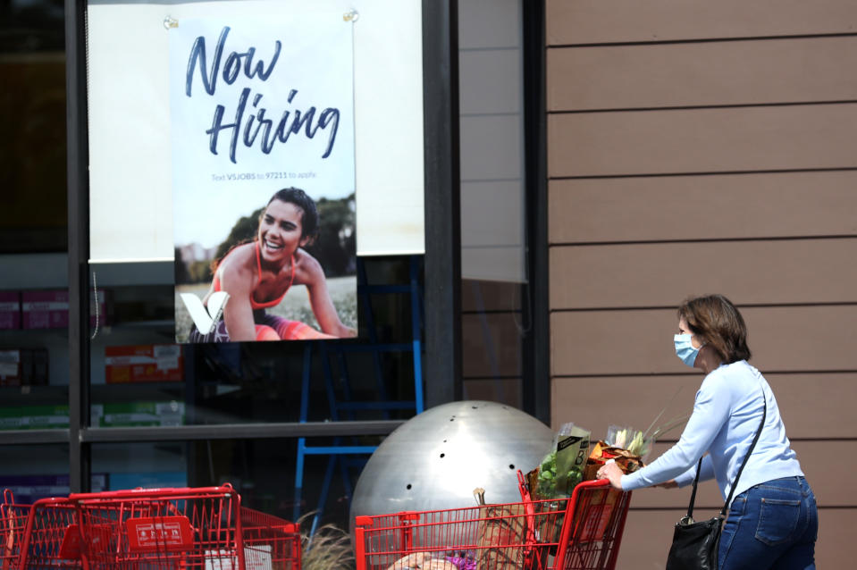 LARKSPUR, CALIFORNIA - APRIL 02: A pedestrian walks by a now hiring sign at a The Vitamin Shoppe on April 02, 2021 in Larkspur, California. According to a report by the Bureau of Labor Statistics, the U.S. economy added 916,000 jobs in March and the unemployment rate dropped to 6 percent. Leisure and hospitality jobs led the way with 280,000 new jobs followed by restaurants with 176,000 jobs and construction with 110,000 new positions. (Photo by Justin Sullivan/Getty Images)