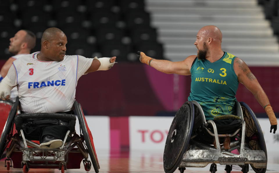 France's Cedric Nankin, left, and Australia's Ryley Batt chat during a Wheelchair Rugby pool match at the Tokyo 2020 Paralympic Games, Thursday, Aug. 26, 2021, in Tokyo, Japan. There are 4,403 Paralympic athletes competing in Tokyo, each with unique differences that have to be classified. Lines have to be draw, in the quest for fairness, to group similar impairments, or impairments that yield similar results. (AP Photo/Shuji Kajiyama)