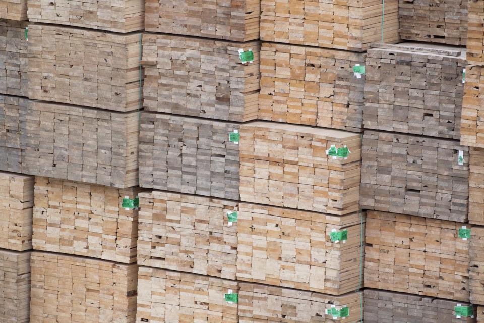 Softwood lumber is pictured along the Fraser River in Richmond, B.C., Tuesday, April 25, 2017. Canfor Corp. swung to a loss in the third quarter on weaker lumber market conditions especially in British Columbia and lower earnings in the pulp and paper segments. THE CANADIAN PRESS/