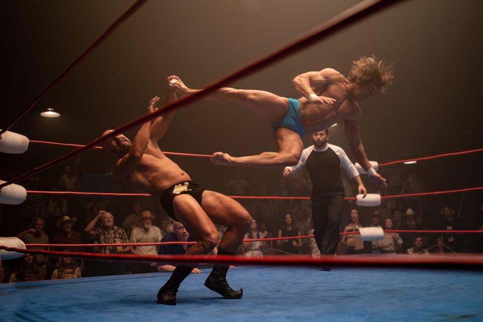 Kevin Von Erich (Zac Efron, right) dropkicks a foe in a wrestling match in "The Iron Claw."