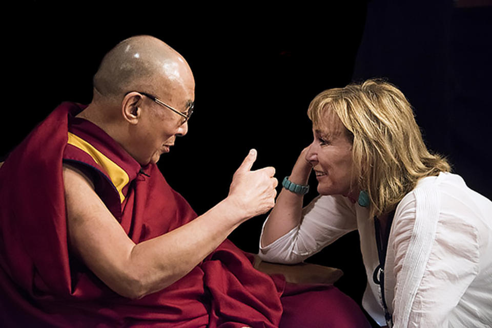 Filmmaker Peggy Callahan leans in during a discussion with the Dalai Lama. (Courtesy Miranda Penn Turin)