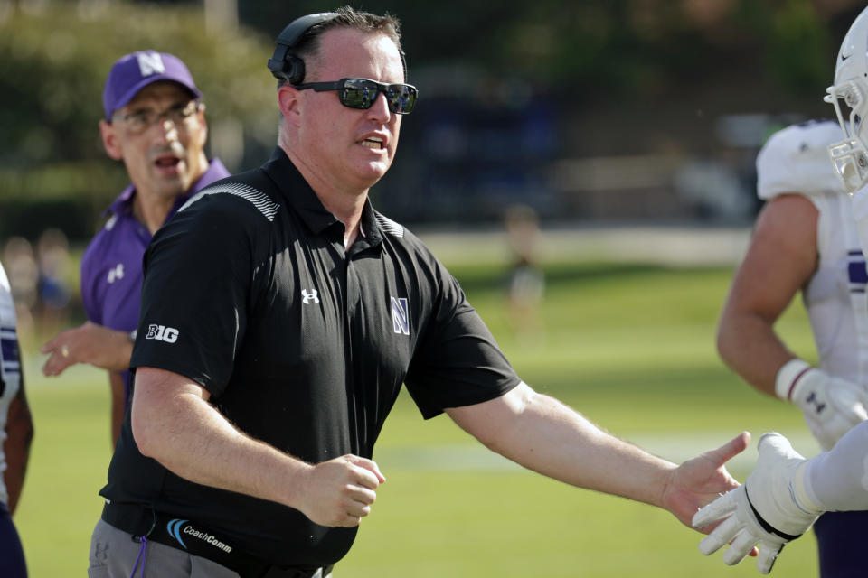 Northwestern head coach Pat Fitzgerald congratulates the players after they recovered a fumble against Duke during the first half of an NCAA college football game in Durham, N.C., Saturday, Sept. 18, 2021. (AP Photo/Chris Seward)