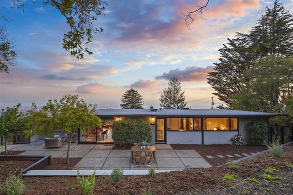 Spanning across the backyard, the cement patio offers an idyllic oasis for private outdoor entertaining.