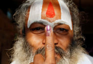 <p>A Sadhu, or Hindu holy man shows his ink marked finger after voting during the state assembly election, in the town of Ayodhya, in the state of Uttar Pradesh, India, February 27, 2017. (Cathal McNaughton/Reuters) </p>