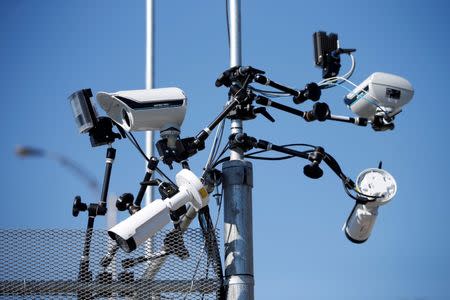 Surveillance cameras are pictured on a security fence near the site of the upcoming G7 leaders' summit in Quebec's Charlevoix region, in La Malbaie, Quebec, Canada, May 24, 2018. REUTERS/Chris Wattie/Files