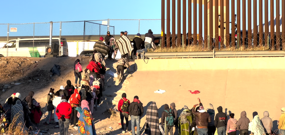 Migrants standing in line at the US southern border
