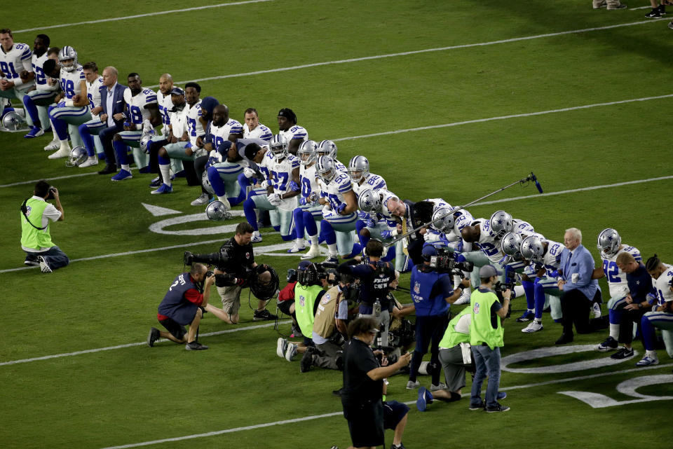 The Dallas Cowboys, led by owner Jerry Jones, far right, take a knee prior to the national anthem on Monday night. (AP)