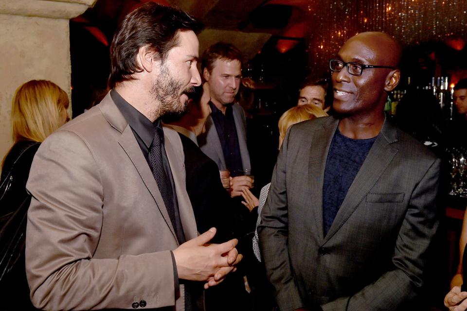 Keanu Reeves (L) and Lance Reddick talk at the after party for the screening of Lionsgate Films' "John Wick"