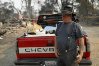 Ed Bledsoe cries after searching through what remains of his home, Monday, Aug. 13, 2018, in Redding, Calif. Bledsoe's wife, Melody, great-grandson James Roberts and great-granddaughter Emily Roberts were killed at the home in the Carr Fire. (AP Photo/John Locher)